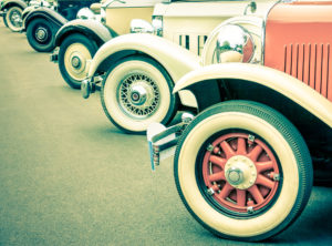 Perfect diagonal of vintage car wheels representing the modern passion for antique retro classic vehicles